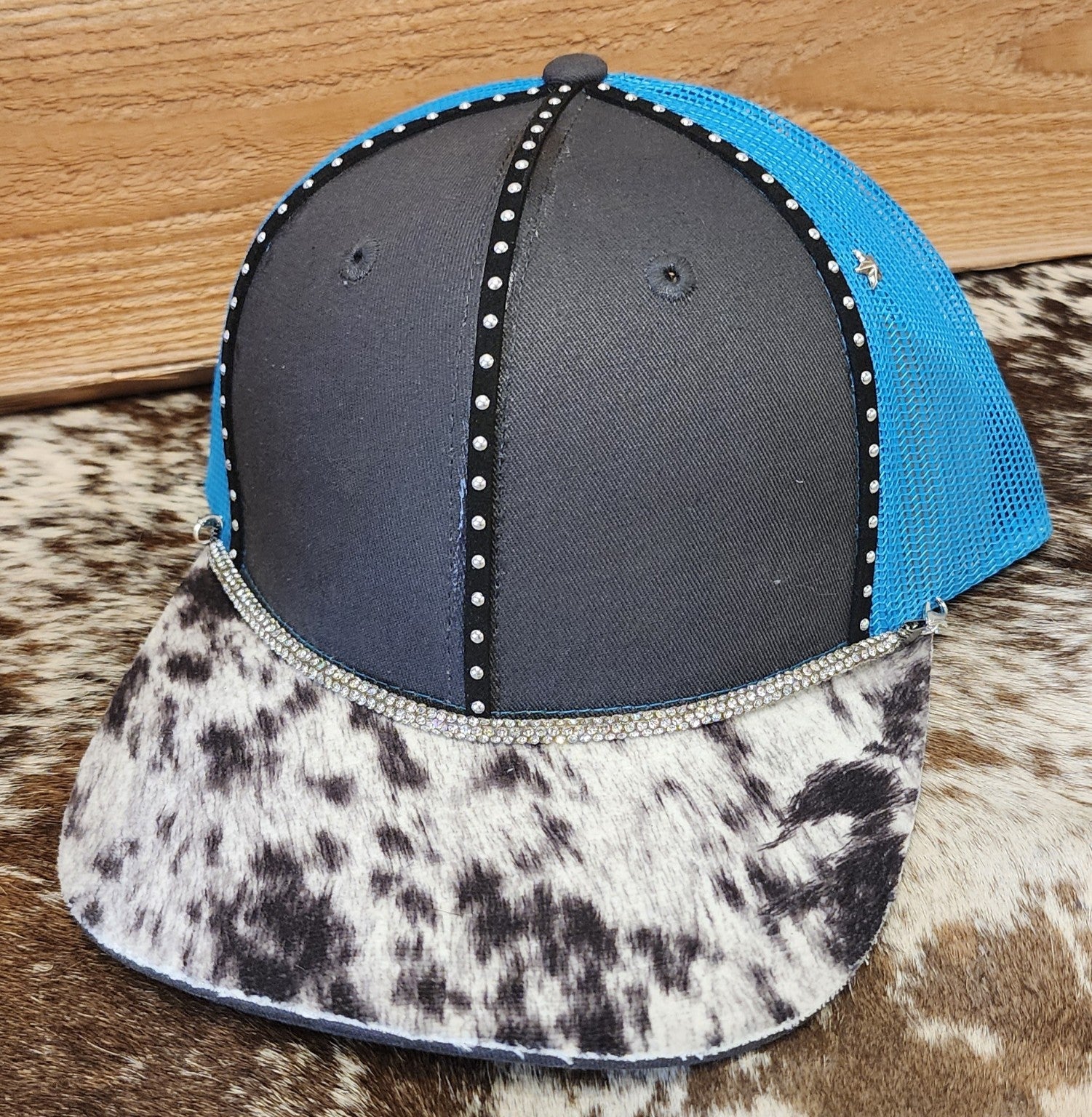 One-of-a-kind blue mesh snapback with cowhide-patterned bill and rhinestone accents