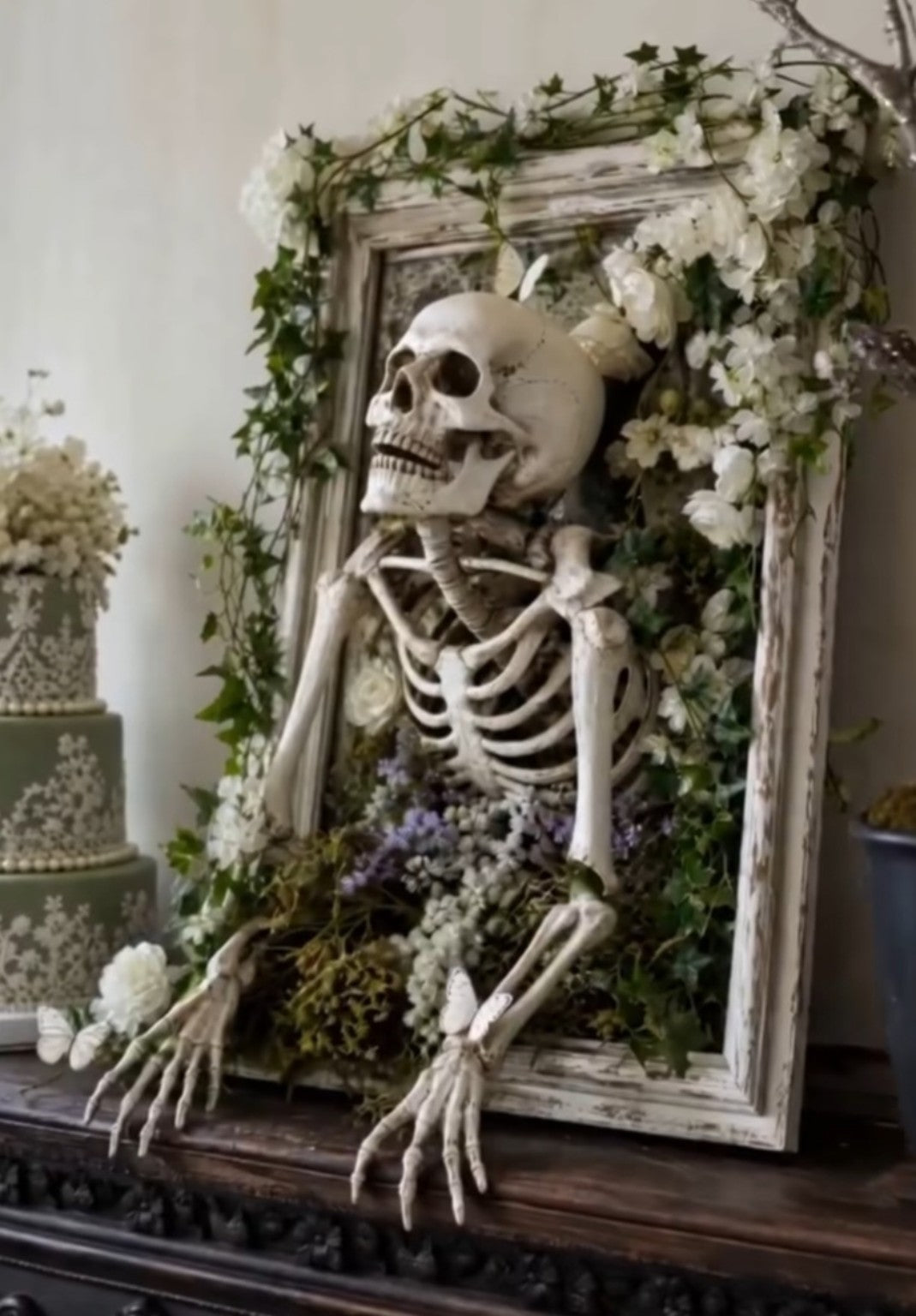 Spooky Wreath Workshop example with skeleton, flowers, greenery, and vintage frame