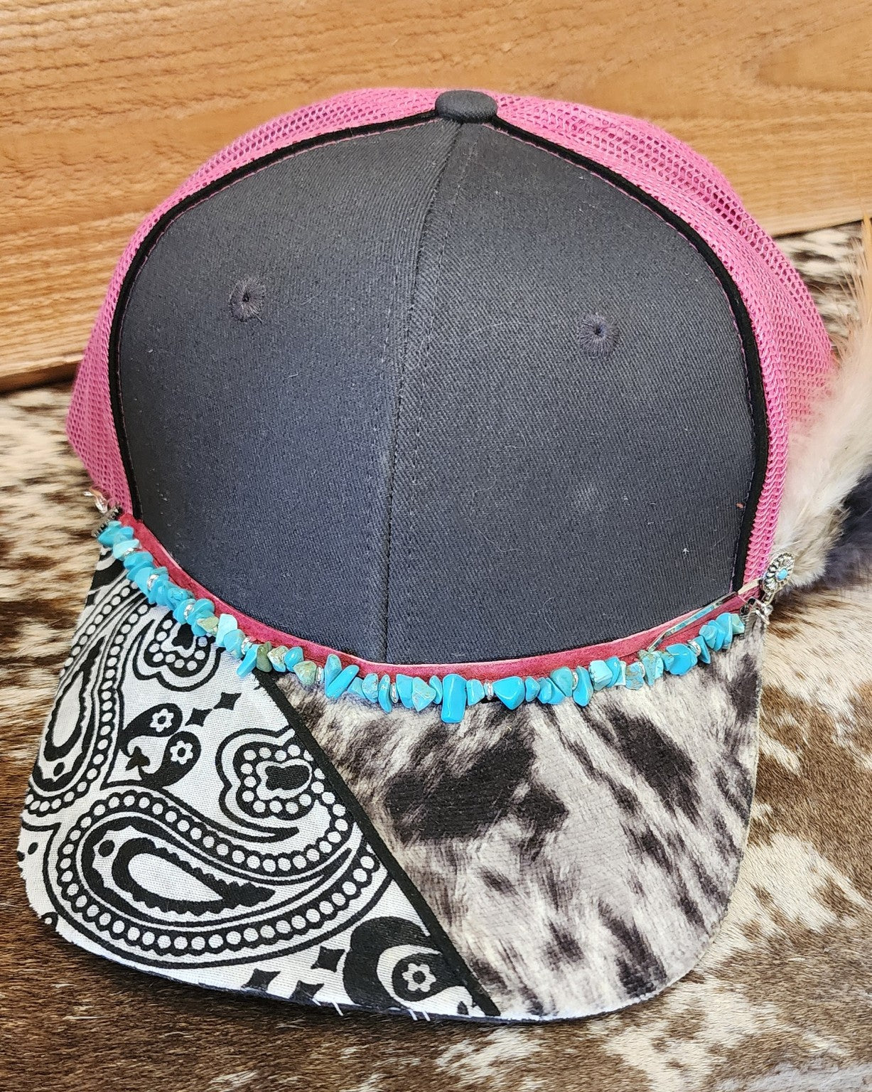 Front view of one-of-a-kind turquoise and feather handcrafted snapback hat
