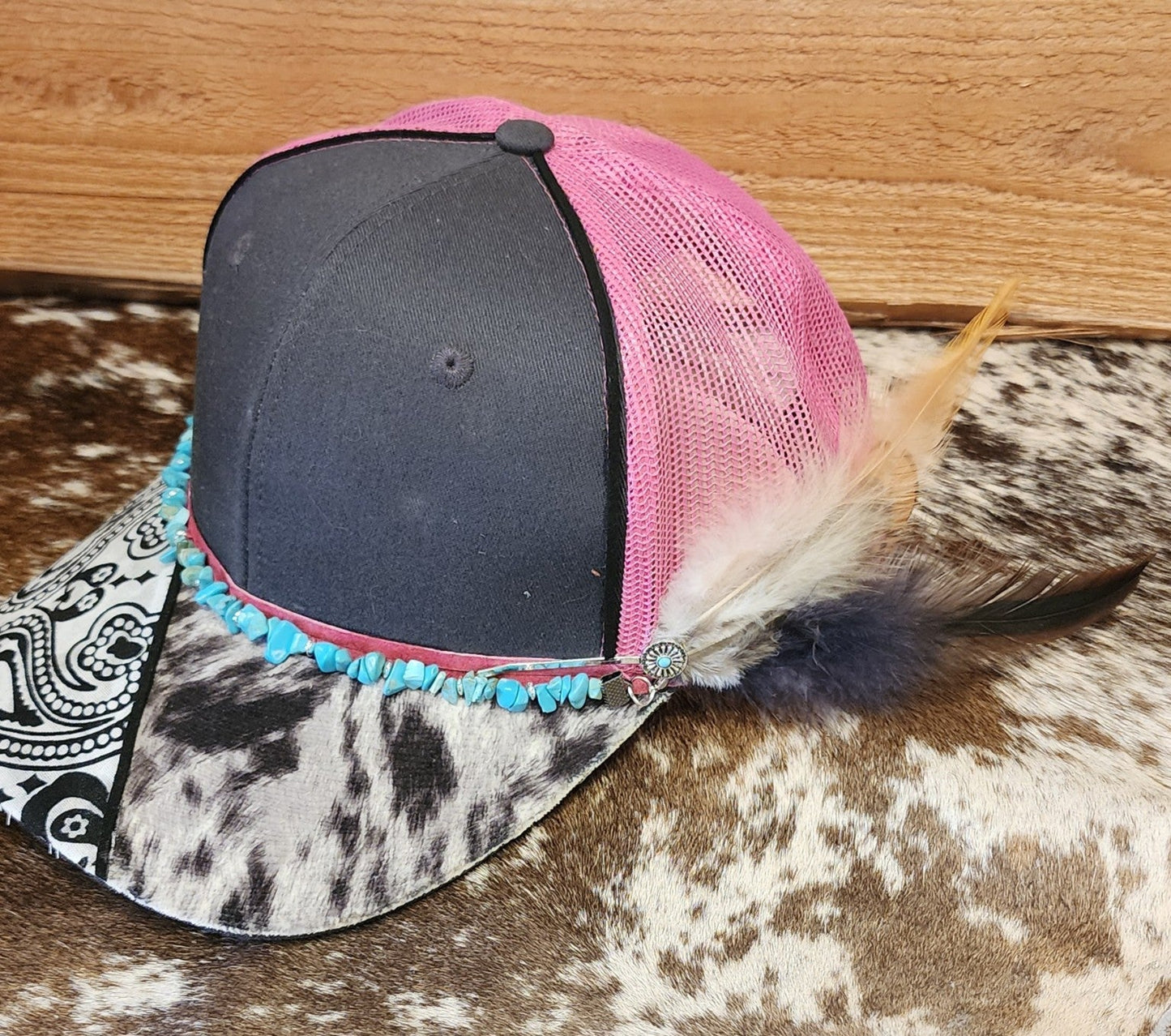Side view of one-of-a-kind turquoise and feather handcrafted snapback showing removable feather clip