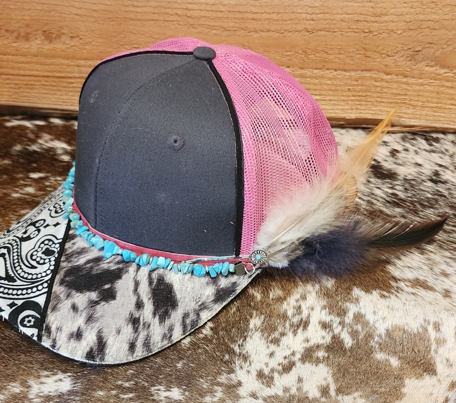 Side view of one-of-a-kind turquoise and feather handcrafted snapback showing removable feather clip