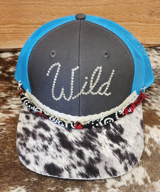 One-of-a-kind handcrafted snapback with rhinestone Wild lettering, blue mesh back and cowhide-patterned bill